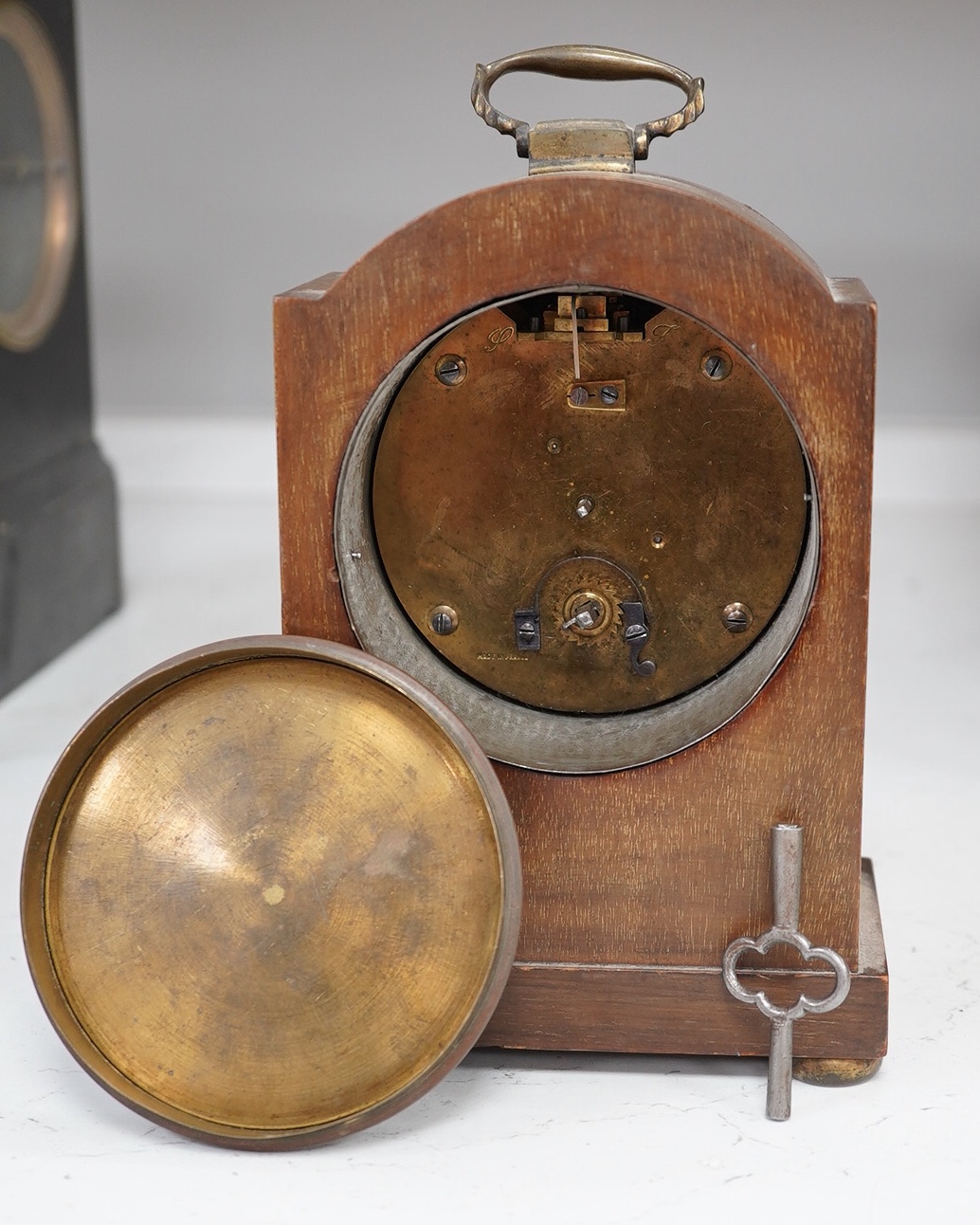 A slate mantel clock and a miniature bracket timepiece, slate clock 25cm high. Condition - miniature bracket time piece, polish on top worn,slate clock has fine scratch.